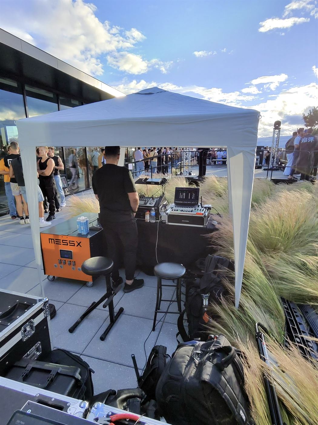 DJ set in full swing on the rooftop with a crowd gathered, running silently on MESSX battery power
